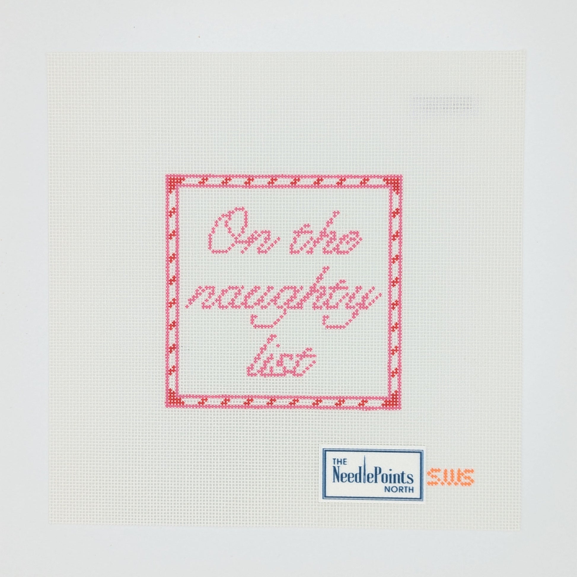 Cross-stitched message 'On the naughty list' on a white fabric with Needlepoint label.