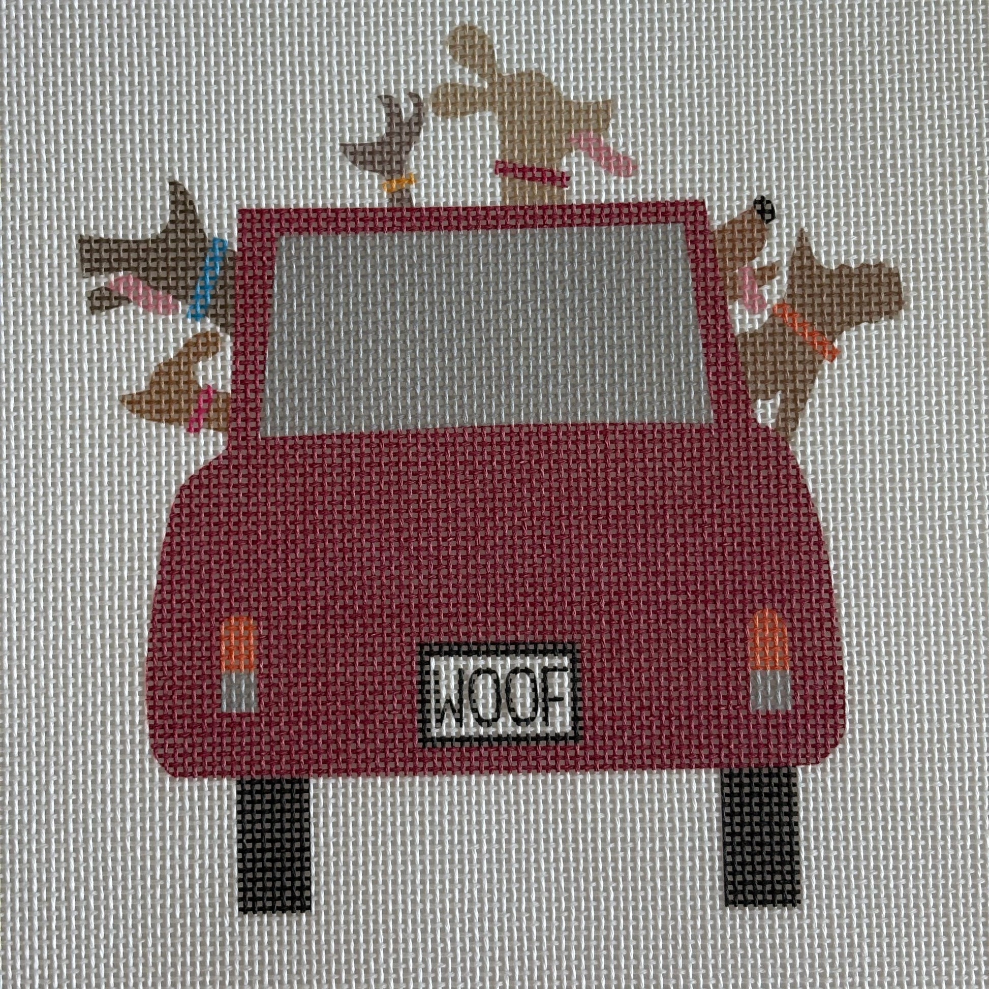 Red car full of dogs