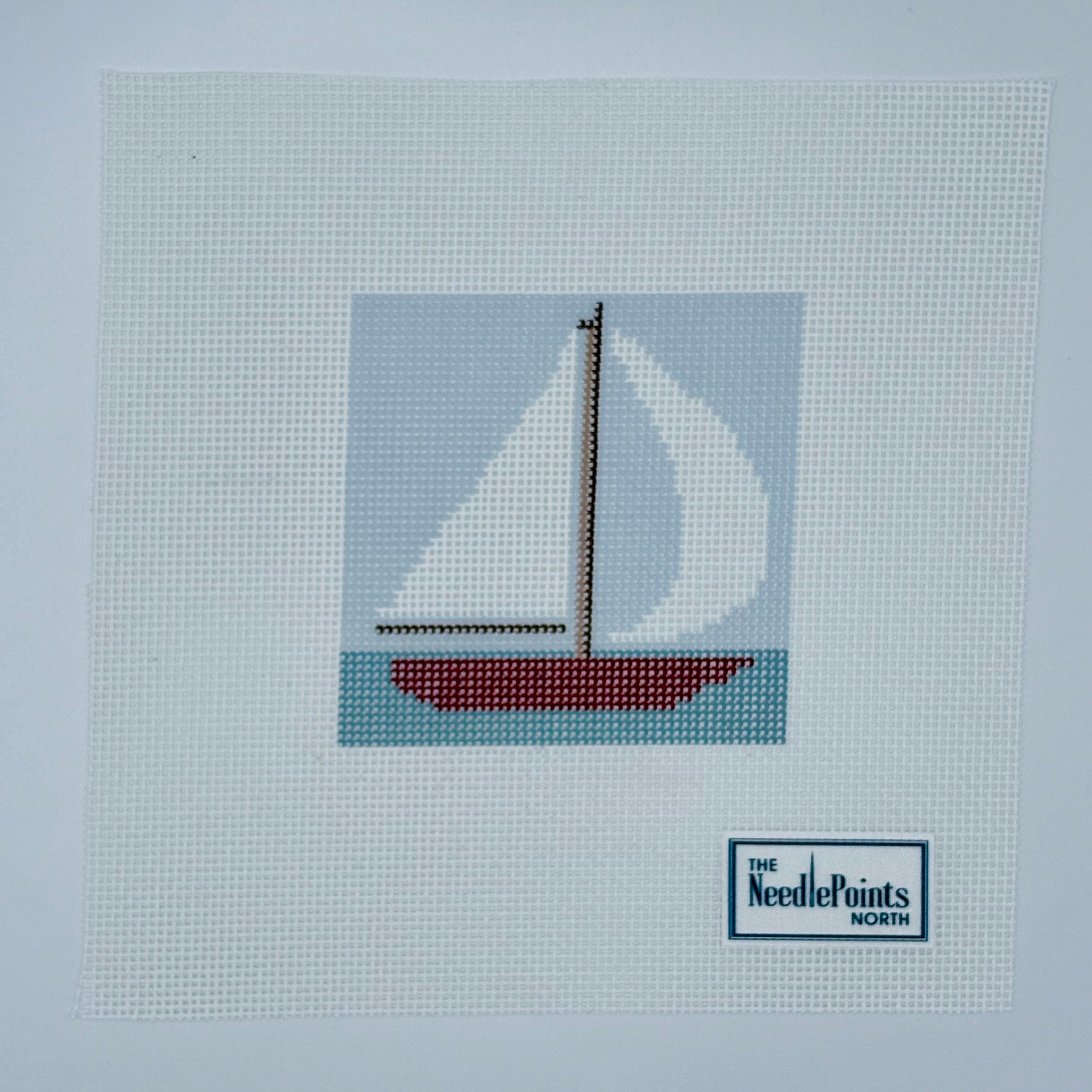 Red sailboat in water square