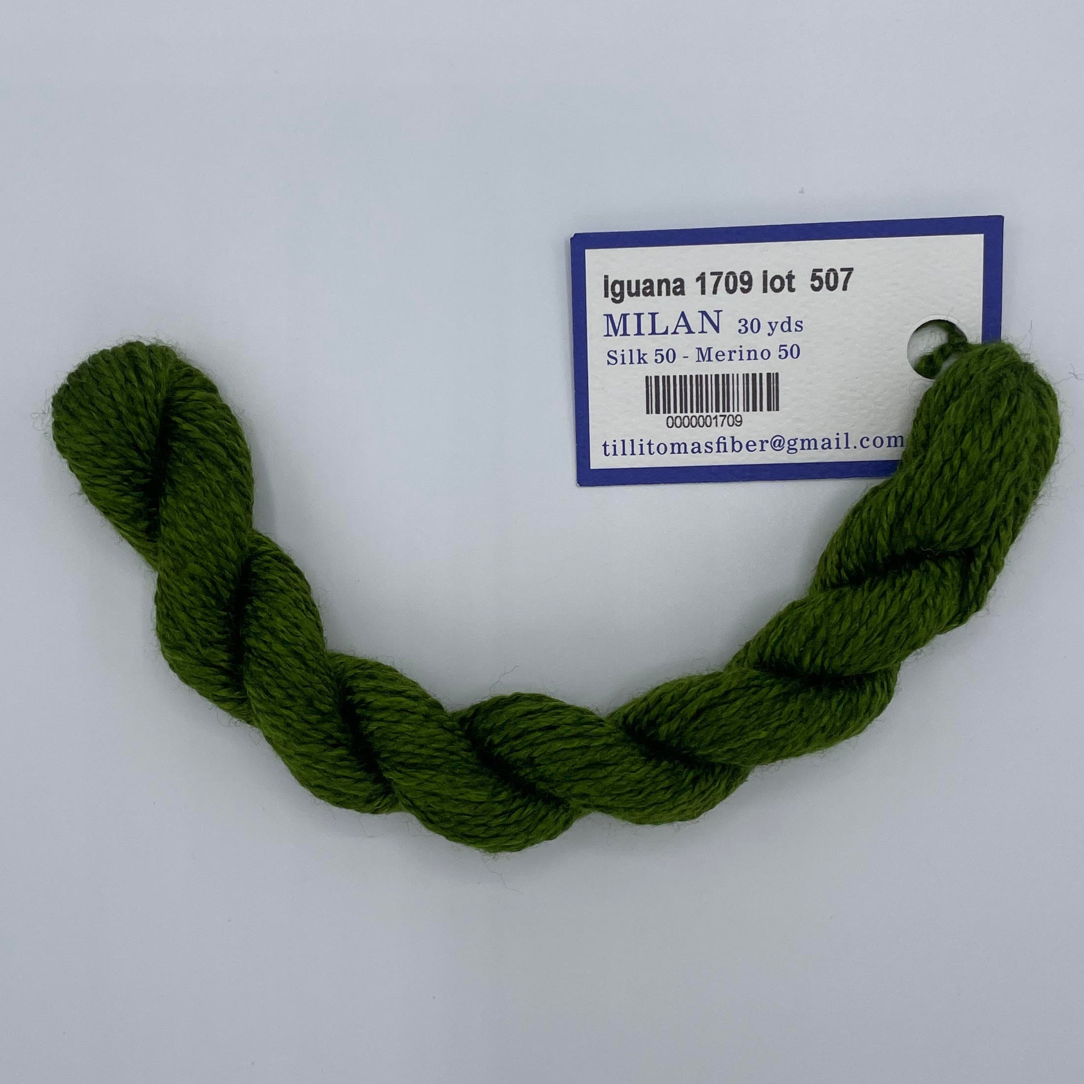 Green skein of yarn with a label on a white background