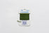 Green thread on a Tilli Tomaz essentials label against a white background